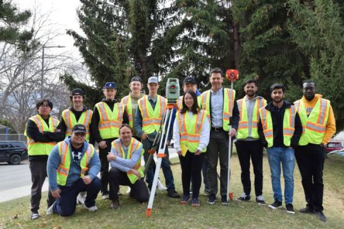 Civil engineering student standing outside in a group posing for the picture