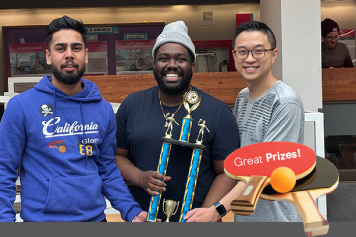 Smiling students with Ping Pong trophy