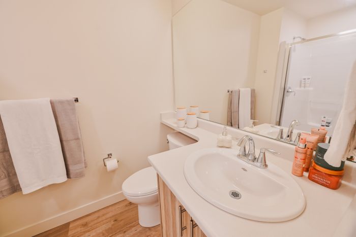 A clean bathroom featuring a toilet and sink with a simple, functional layout.