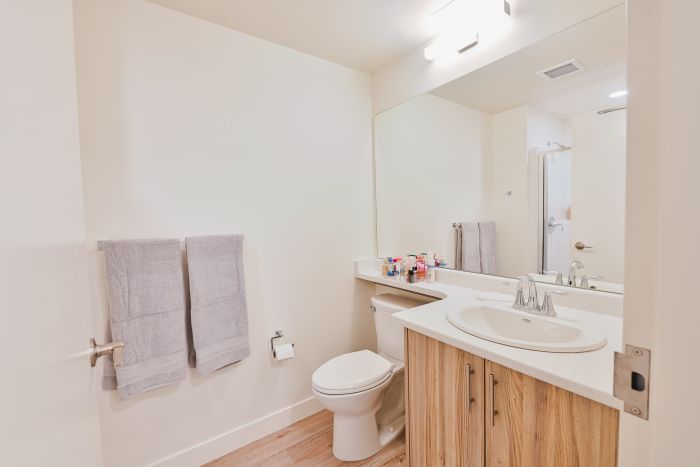 Clean, modern bathroom featuring a sink and toilet in a bright, well-maintained space.