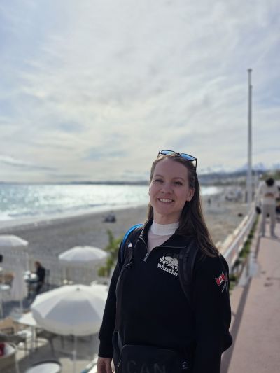 Katelyn at a port overlooking the beach and beach umbrellas