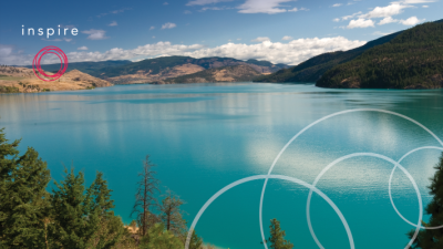 Bright blue waters of Kalamalka lake with hillside in the distance