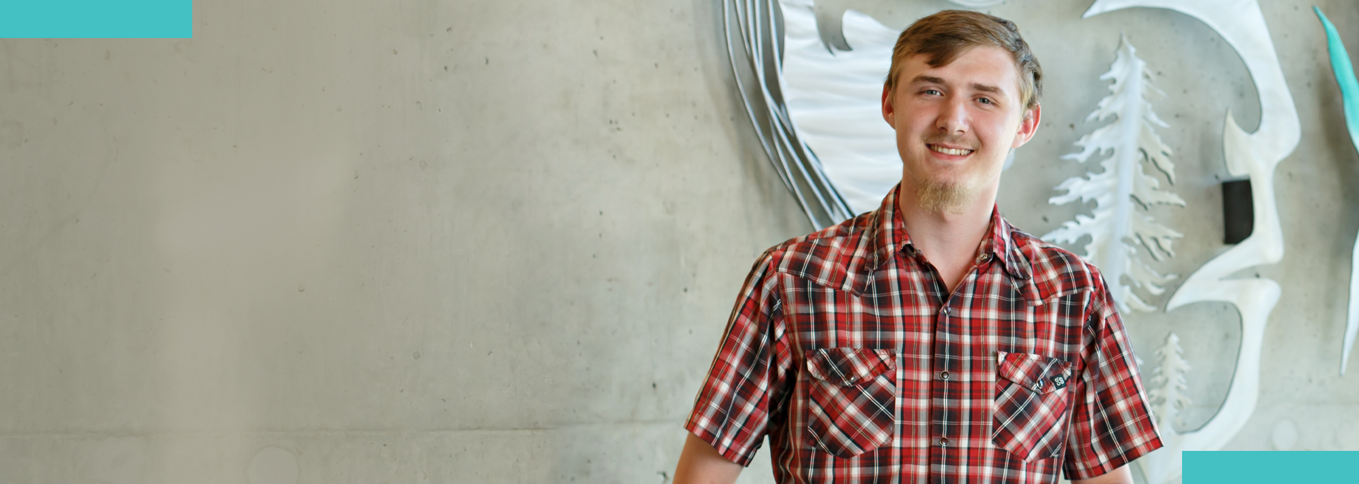 Thomas Klein Smiling in front of Four Chiefs Statue