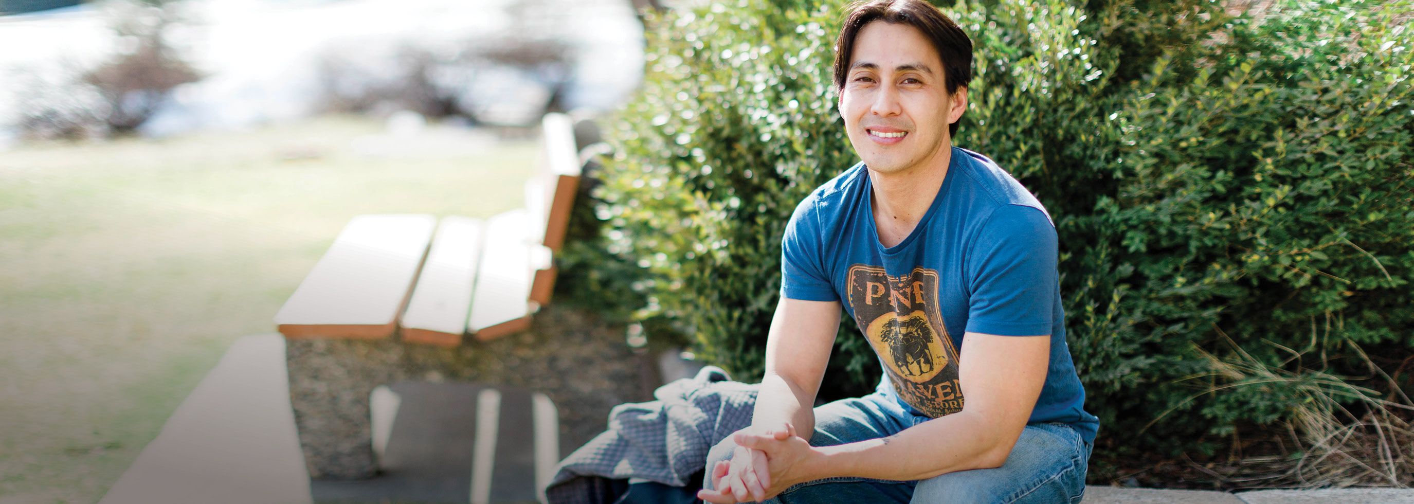Student sitting on a bench outside