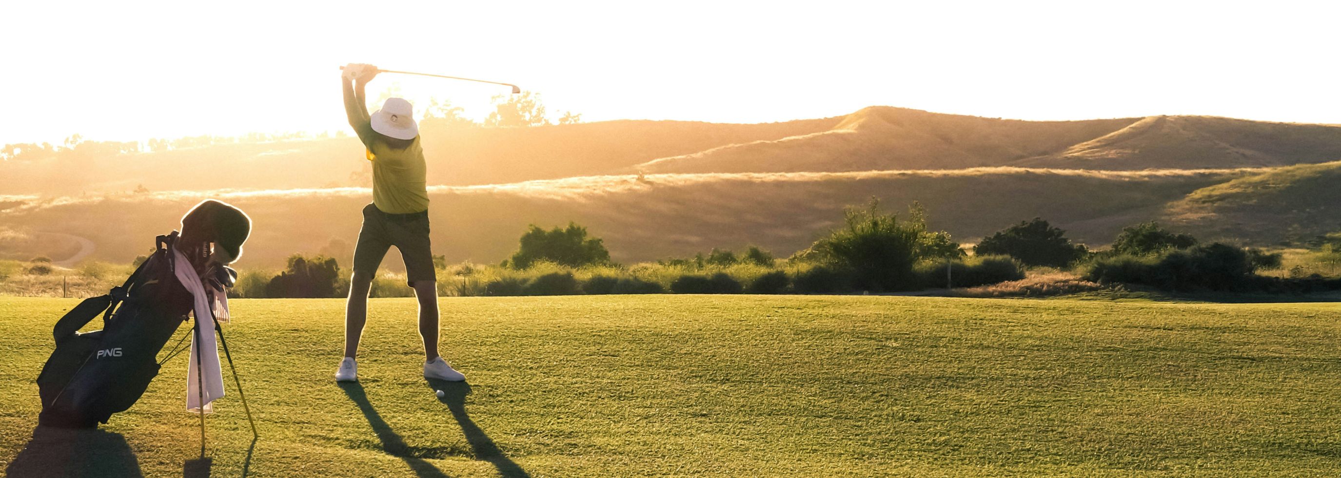 Image of man swinging golf club