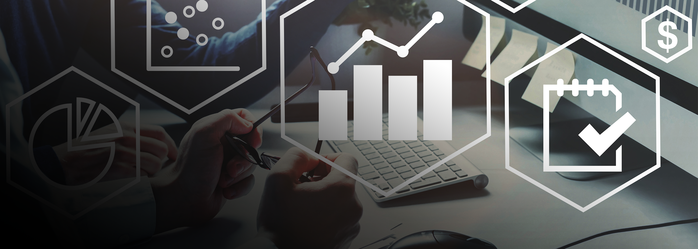Photograph of hands typing on computer with infographic overlay of charts and icons related to data reporting