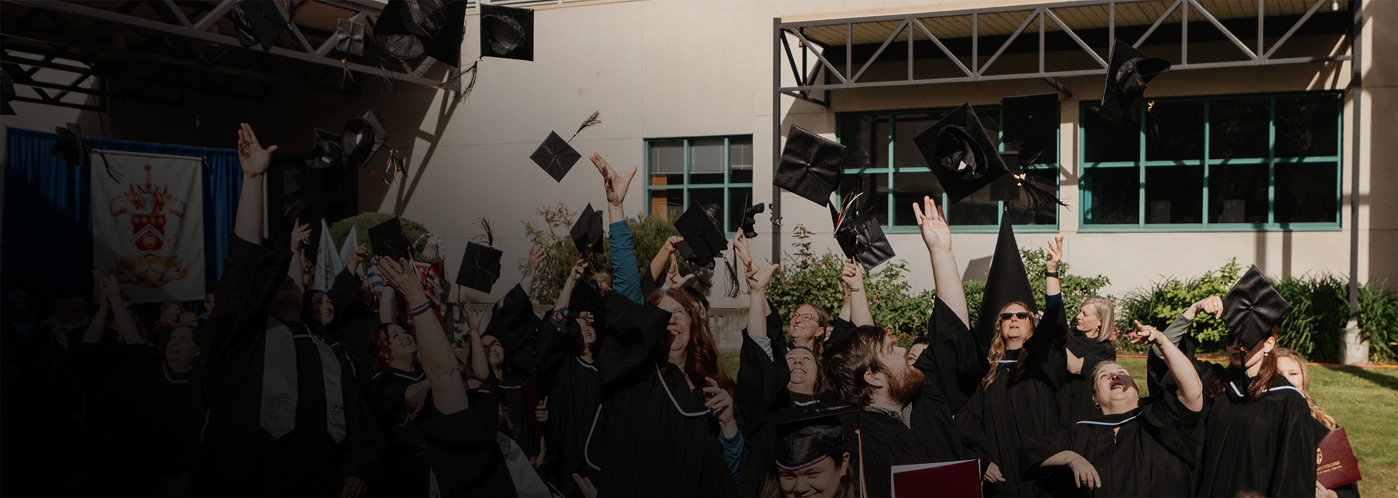 Graduates throw their caps in the air at Salmon Arm cmapus