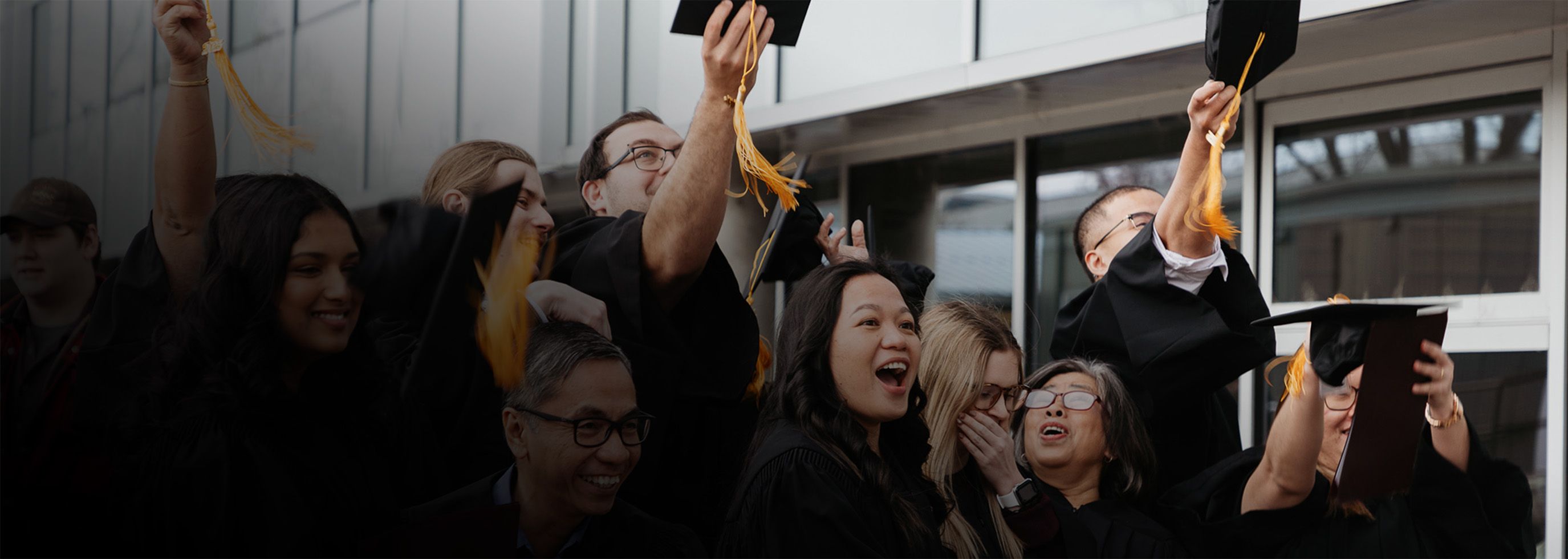 Graduates throw their caps in the air