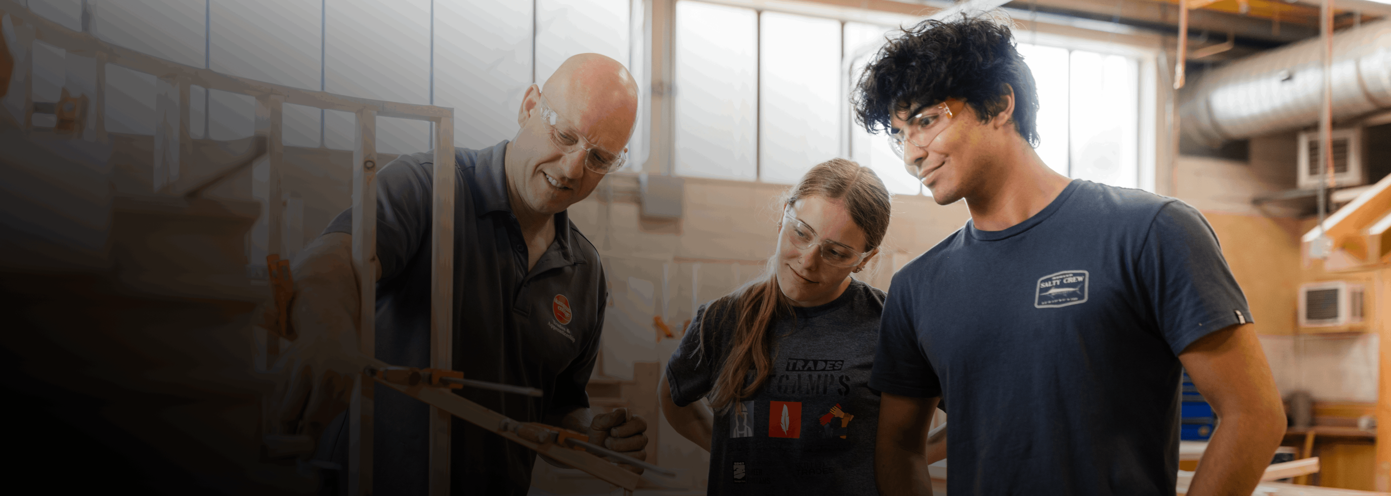Two students learning from their Trades instructor