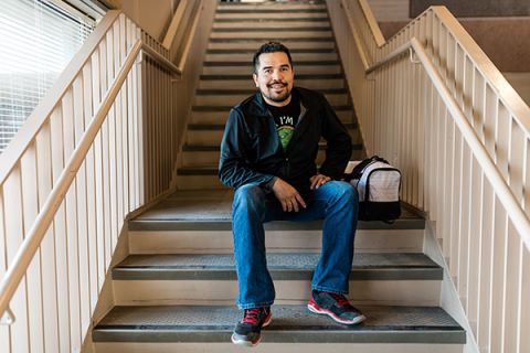 student sitting on staircase in the vernon cafeteria