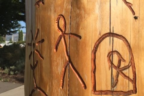 Story poles have carvings in wood