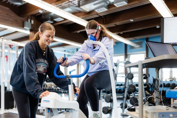 Students work together on proper body movements in the gymnasium