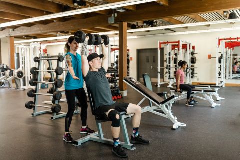 Students work together on proper body movements in the gymnasium