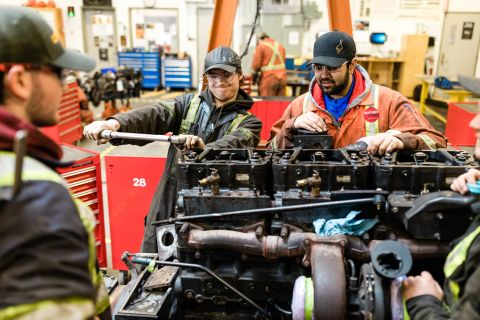 Heavy Duty Mechanical students work on an engine in the shop