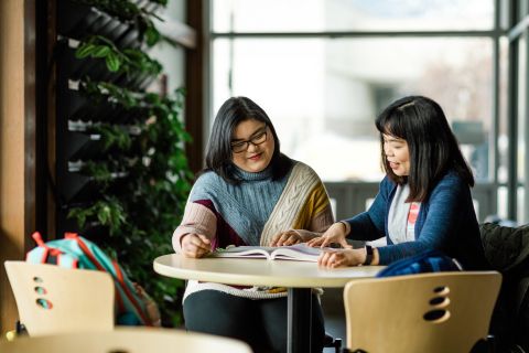 Two female students studying at a table