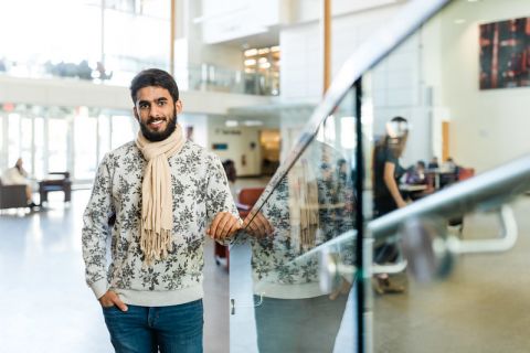 male student standing near staircase