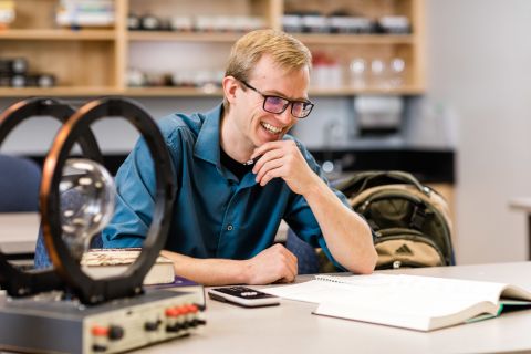 Physics student takes a break in the lab