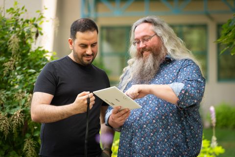 two male instructors reviewing paper