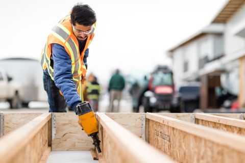 student with nail gun putting together wood