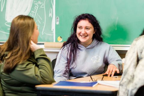 History student works with her classmate during a group assignment