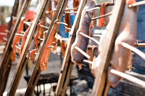 Salmon smoking over open fire during hands-on Indigenous Culinary Arts field trip