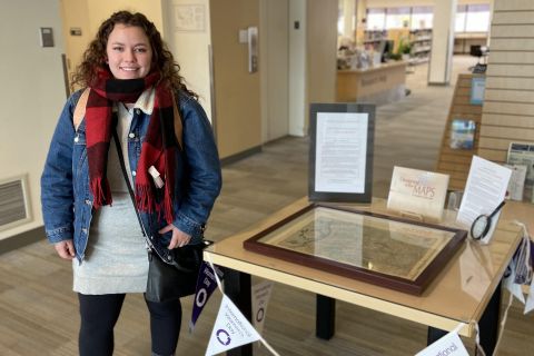 Maddy Moss examining the map on display at the Kelowna campus