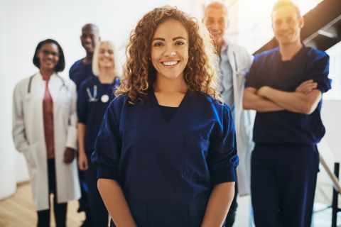 Office worker surrounded by medical office professionals.
