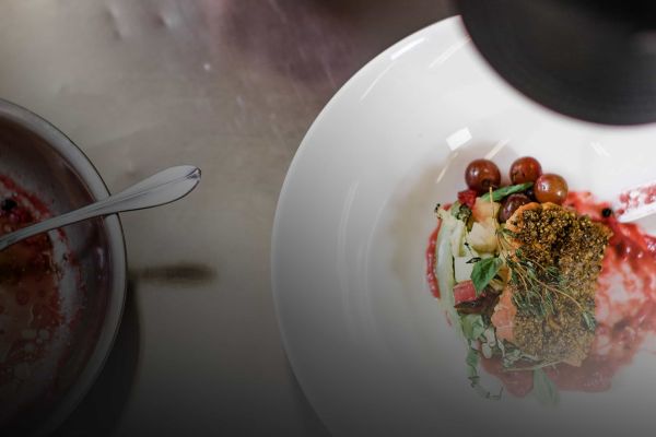Food being plated by a culinary arts student