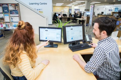 Librarian Helping Student
