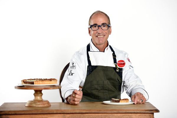 Chef Mike Barillaro takes a break from eating pie to smile at the camera