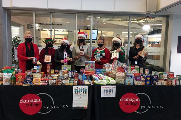 Kelowna staff members are pictured with donations of food on Giving Tuesday.
