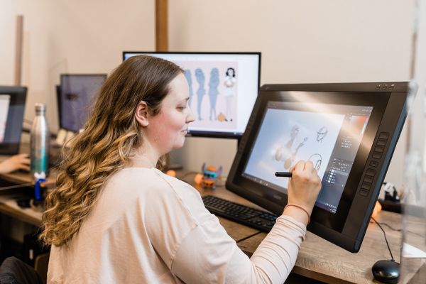 Animation student working on a computer in the studio classroom