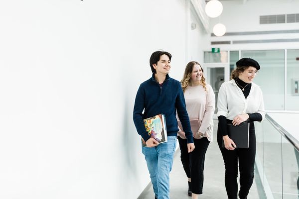 Three animation diploma students walking along the breezeway in the Kelowna Innovation Centre