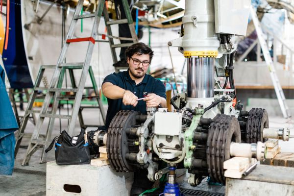 Aerospace student working on an aircraft wheel