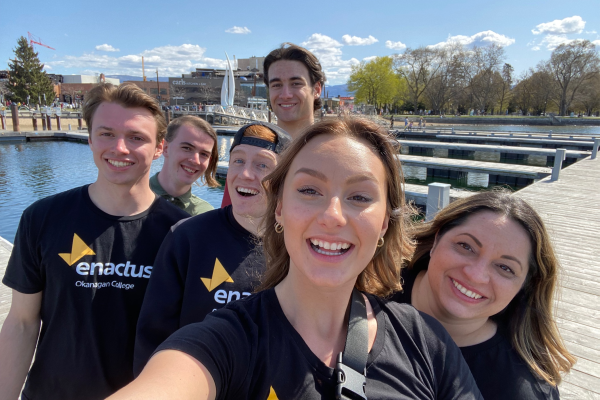 EnactusOC students by the waterfront smiling about their upcoming World Cup performance.