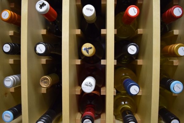 wine bottles stacked up with corks and tops visible