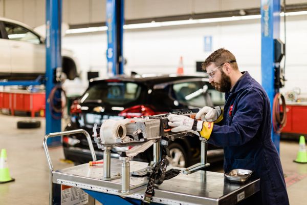 Trades student working on car engine