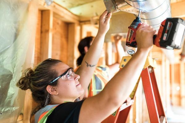 female salmon arm plumbing student working on demo at trades center