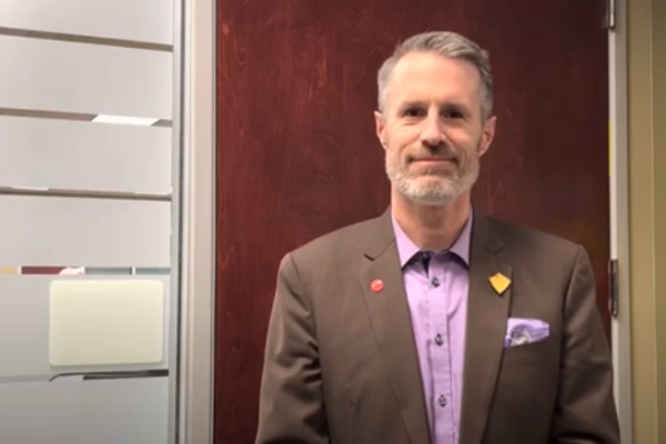 Neil Fassina poses in front of a doorway