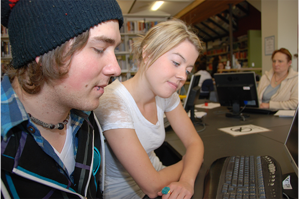 Two students working together at a computer