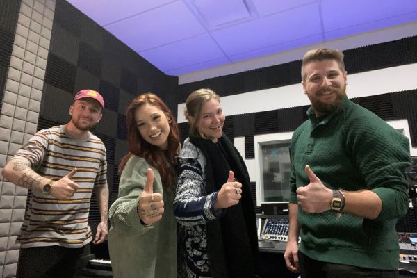 Jessica Bourelle and her musical production team give thumbs ups.