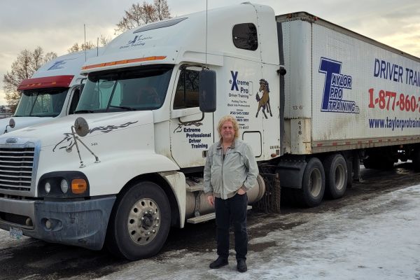Student Keith Schmatlz standing in front of his professional truck.