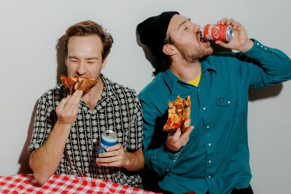 Nonny Beer owners eat slices of pieces while sipping non-alcoholic beverages