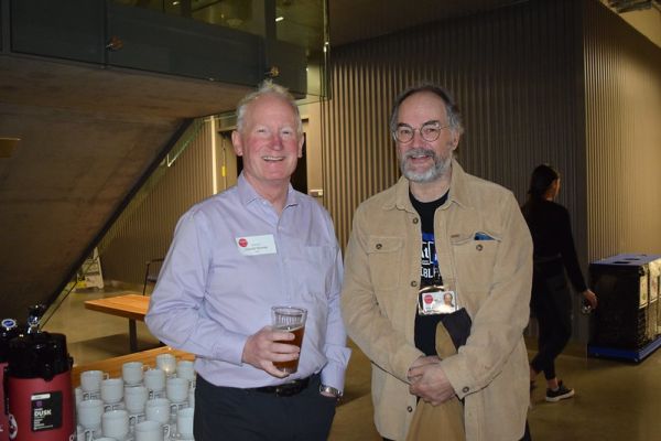 Two retirees pause from the conversation to smile for the camera.