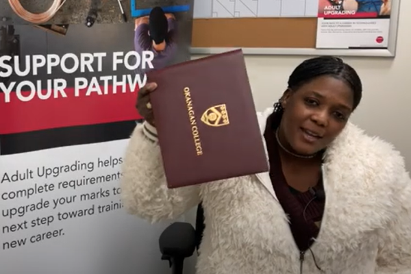 Christine shows off her credential with pride