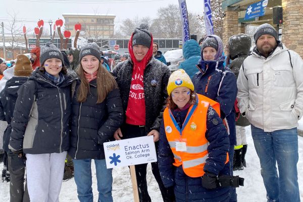 Six students bundled up in winter gear fundraise during Coldest Night of the Year.