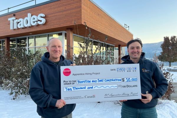 Owner Greg Thompson and apprentice Fedir Solovei in front of the Vernon OC trades building.