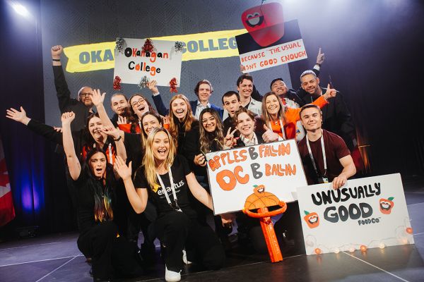 Enactus OC team members celebrate on stage at Nationals.