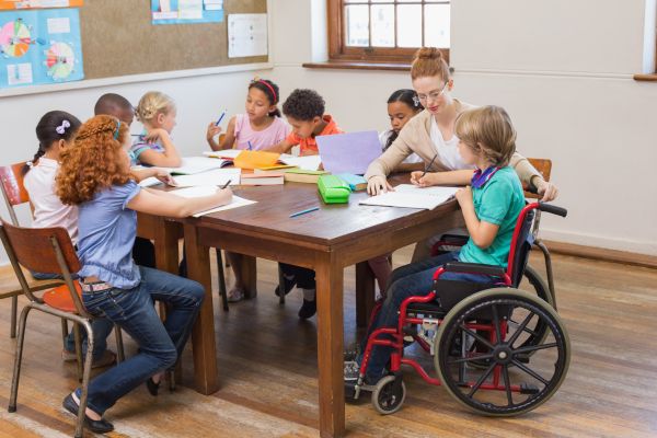 An education assistant helping students