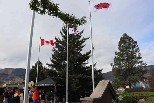 ona and pib flags raised, drummers singing in the background